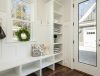 gray and white floral throw pillow beside rack inside room