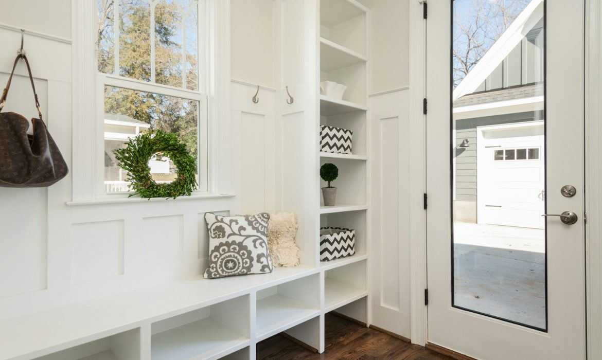 gray and white floral throw pillow beside rack inside room
